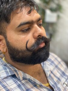 "Davendar Sain, mustache specialist at Styles and Smiles Unisex Salon"