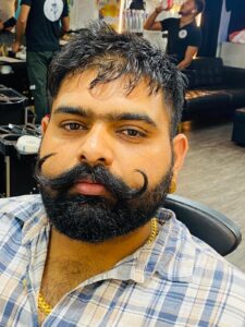"Davendar Sain, mustache specialist at Styles and Smiles Unisex Salon"
