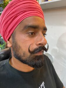 "Davendar Sain, mustache specialist at Styles and Smiles Unisex Salon"